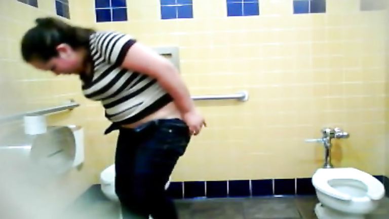 Chubby woman takes a leak in a public WC