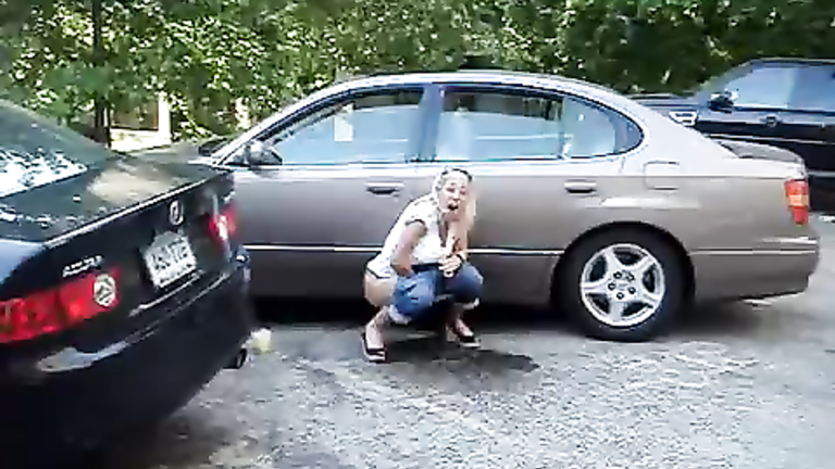 Laughing chick relieves herself in a parking lot