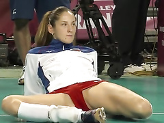 Leggy volleyball girl stretches before a match