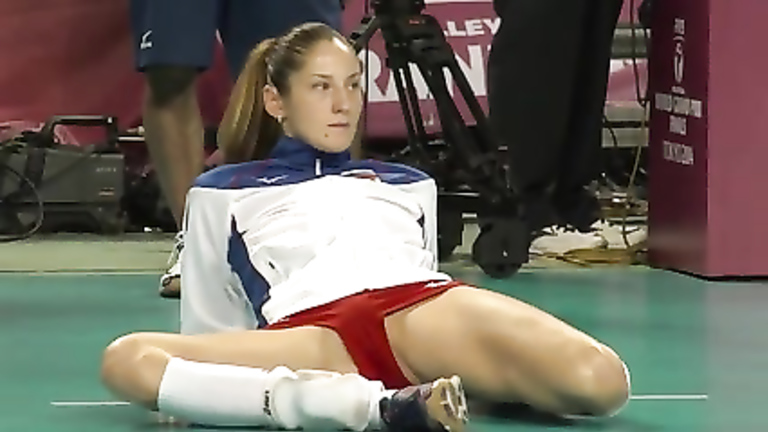 Leggy volleyball girl stretches before a match