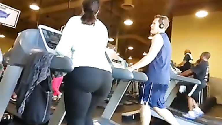 Fat ass woman walks on the treadmill