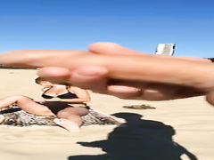 Stroking penis to a bikini woman on the beach