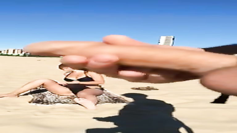 Stroking penis to a bikini woman on the beach