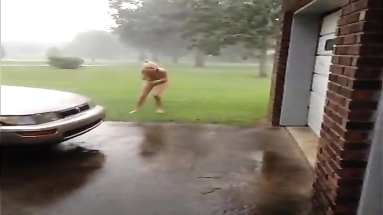 Naked girlfriend runs outdoors in a hurricane