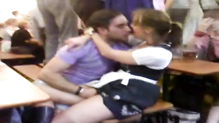 Dude tickles his girlfriend at Oktoberfest