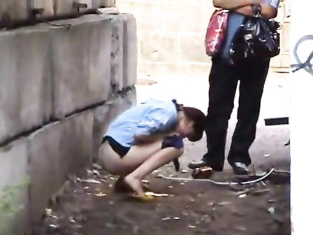 Cutie pissing in an alley as her man waits