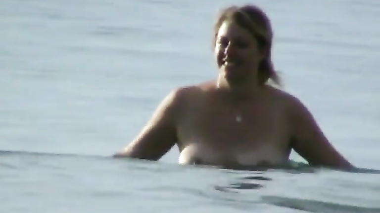 Milf with saggy tits goes skinny dipping in the ocean