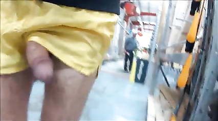 Flashing cock in nylon shorts at the hardware store