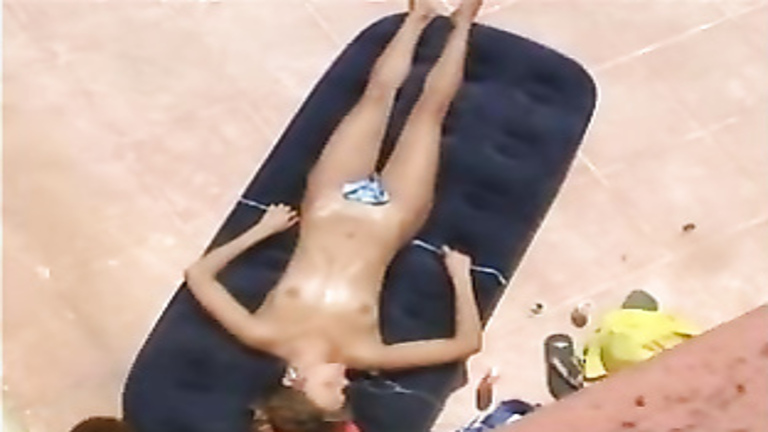 Skinny bikini beauty tans naked under the sun