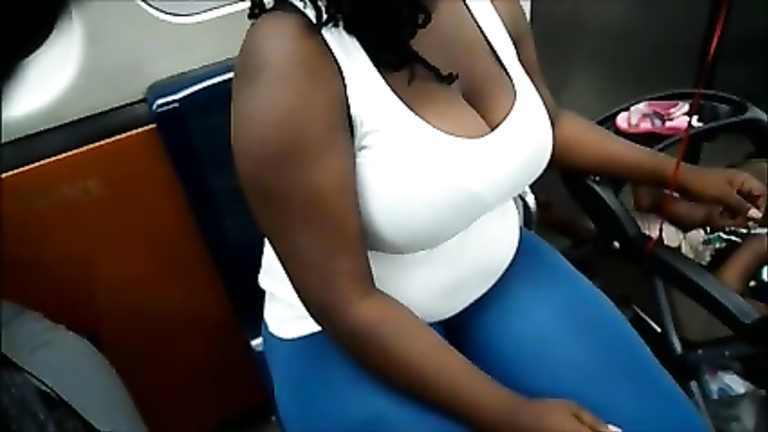 Big black tits on the subway make great cleavage