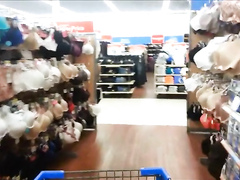 Shopping girl pisses on clothes and puts them back