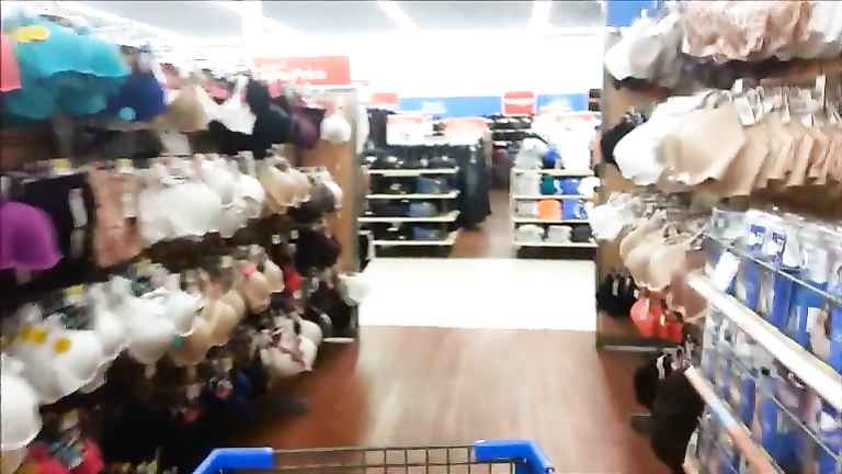 Shopping girl pisses on clothes and puts them back