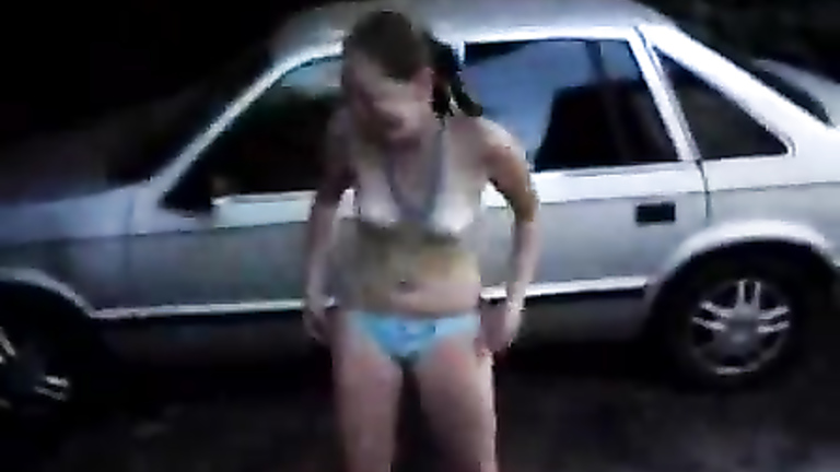 Nice striptease from a bikini girl in the driveway