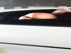 Cutie in a limo flashes her tits and ass