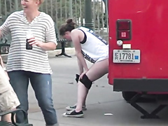 Desperate German girl takes a pee against a truck in public