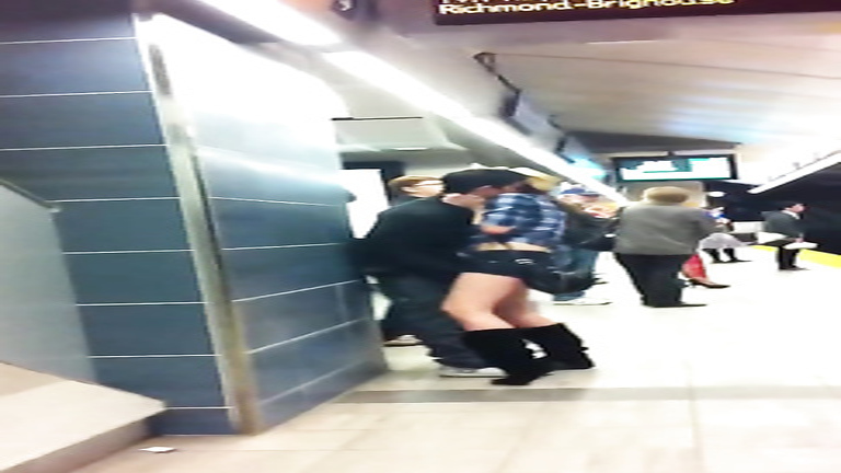 Fooling around with his GF at the metro stop