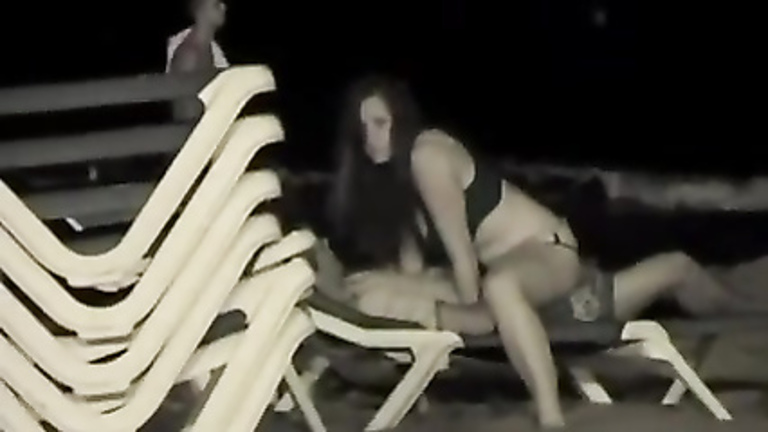 Night sex on a public beach with the girl on top