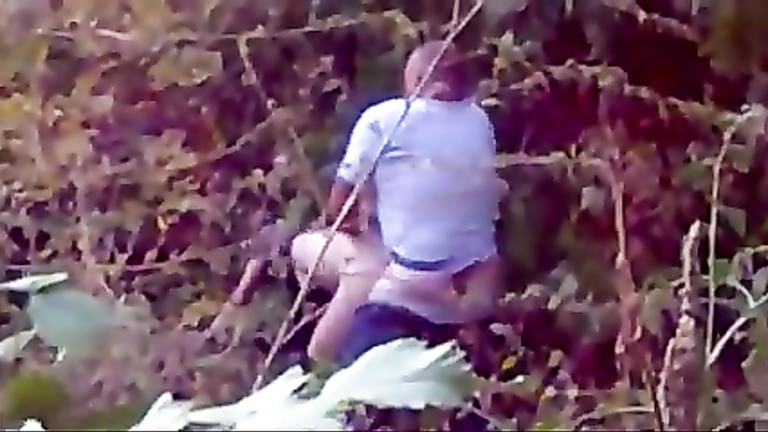 Man caught on cam banging a slut in the bushes