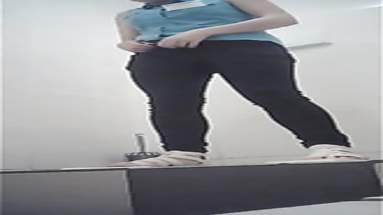 Female employee squats over the public toilet and relieves herself